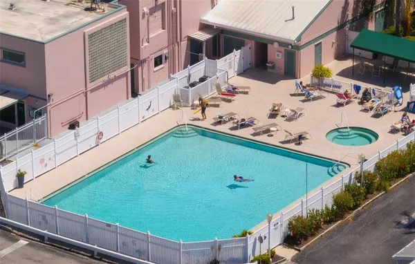 a view of a backyard with furniture and outdoor kitchen
