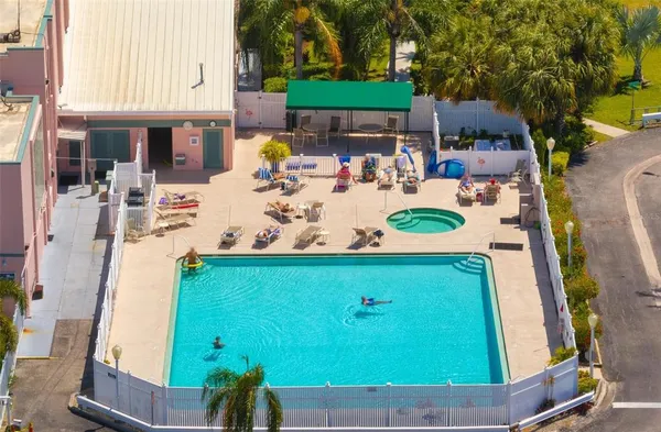 a view of a patio with table and chairs potted plants and large tree