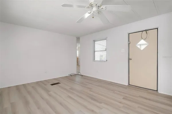 wooden floor in an empty room with a window