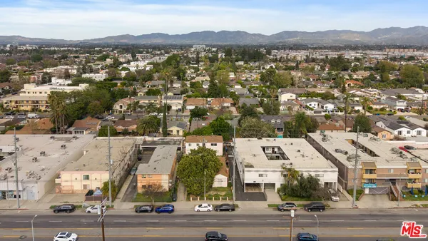 an aerial view of residential houses with outdoor space