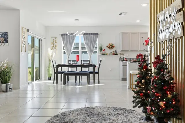 a view of a hallway with wooden floor and a potted plant