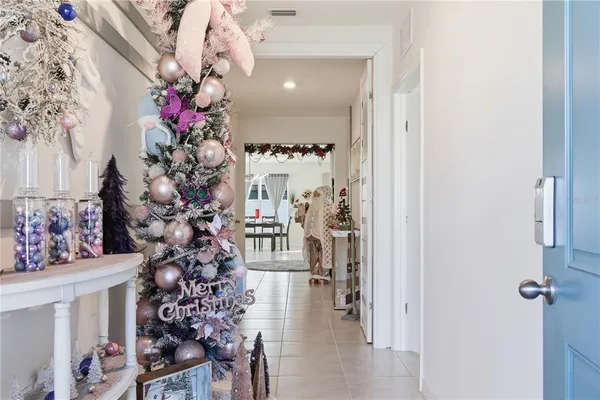 a view of a hallway to a window and a flower pot