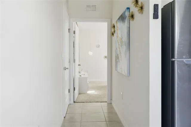 a kitchen with stainless steel appliances white cabinets and a refrigerator