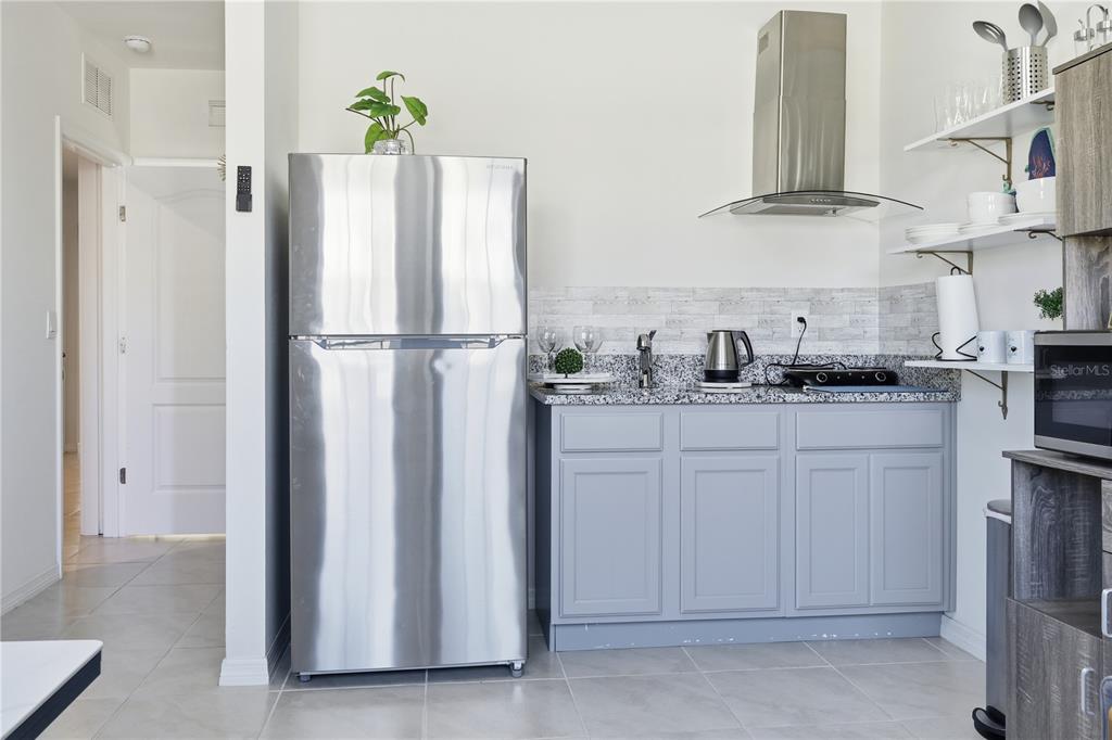 3862 Resting Robin Avenue Bartow, FL 33830 - Photo 18 of 41 a kitchen with stainless steel appliances white cabinets and a refrigerator