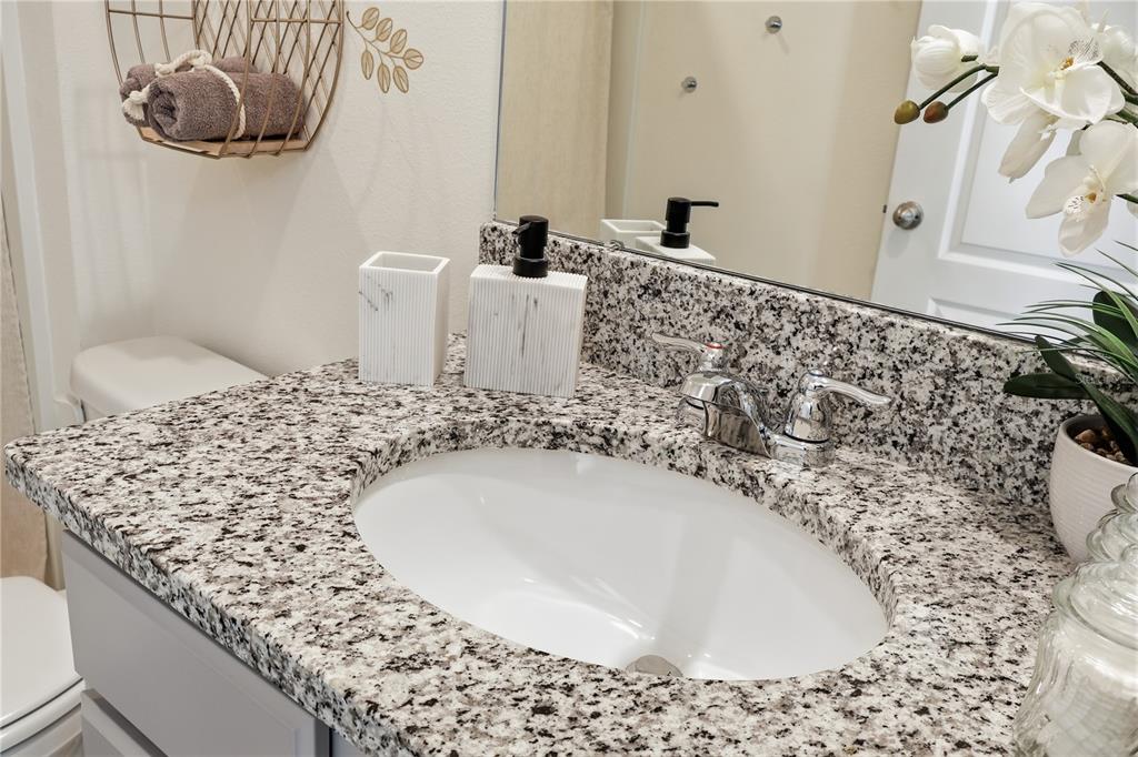 3862 Resting Robin Avenue Bartow, FL 33830 - Photo 20 of 41 a bathroom with a granite countertop sink and a mirror