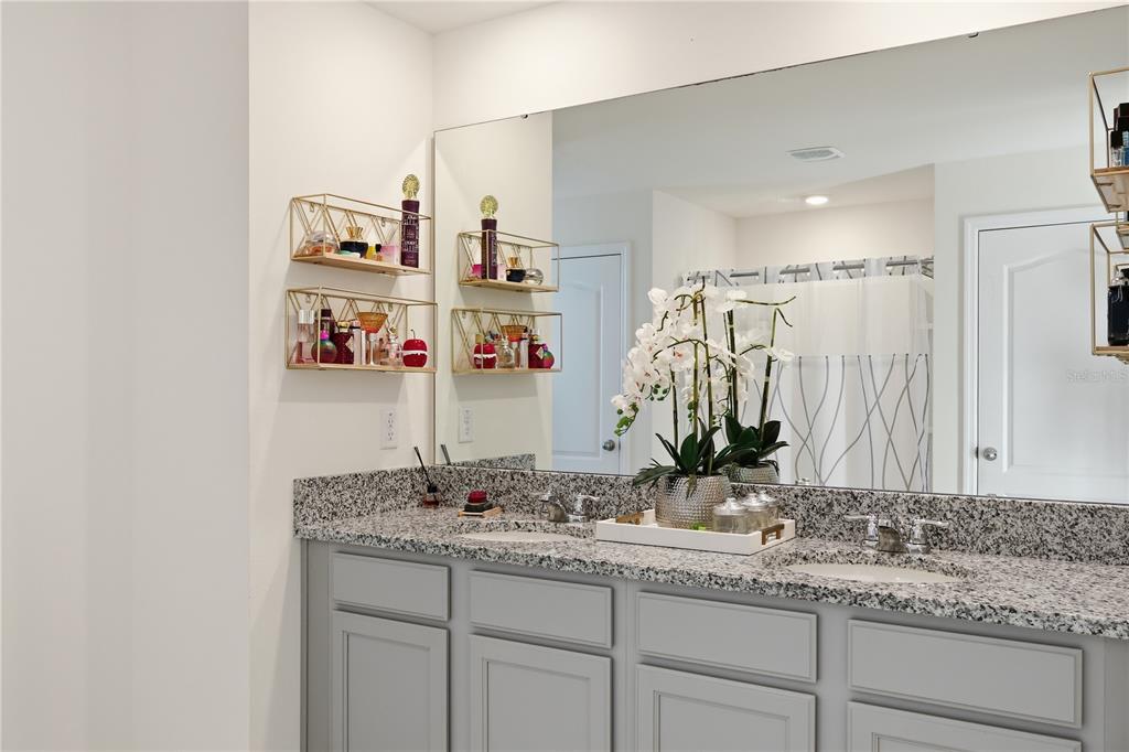 3862 Resting Robin Avenue Bartow, FL 33830 - Photo 25 of 41 a bathroom with a granite countertop sink and a mirror