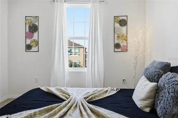 a bedroom with a bed and painting on the wall