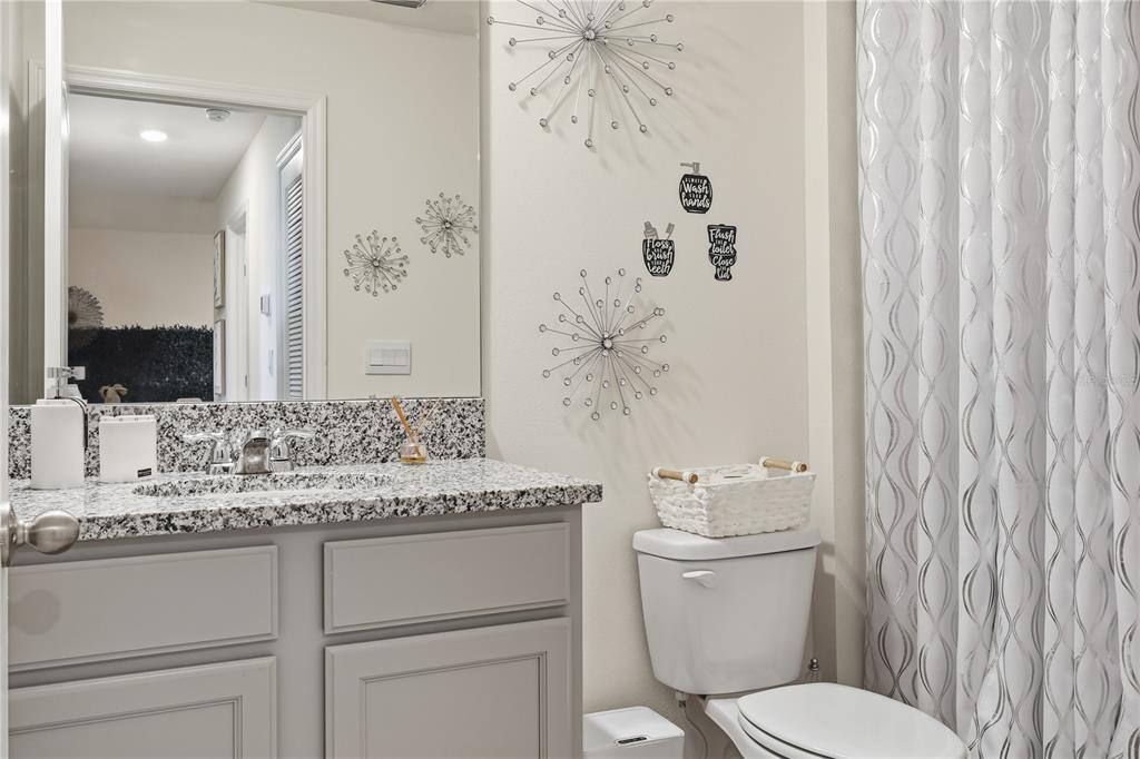 3862 Resting Robin Avenue Bartow, FL 33830 - Photo 32 of 41 a bathroom with a granite countertop sink toilet and mirror