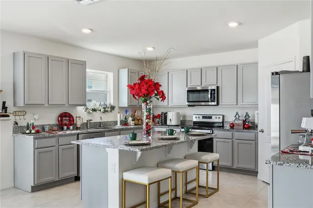 a kitchen that has a sink cabinets counter space and appliances