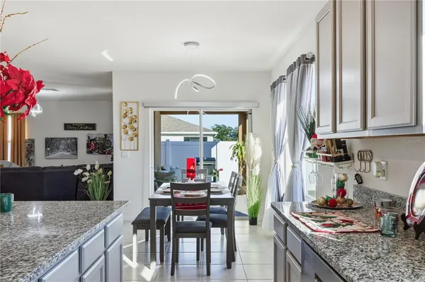 a kitchen with stainless steel appliances granite countertop a stove refrigerator and cabinets