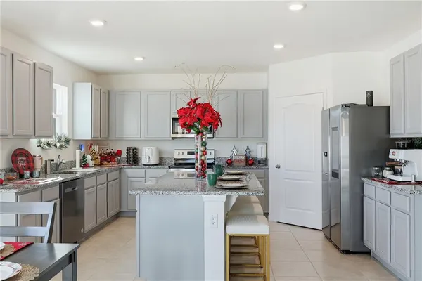 a kitchen that has a lot of cabinets and refrigerator