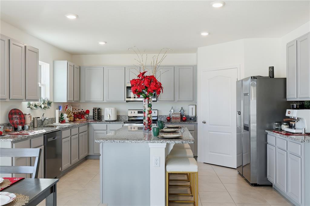 3862 Resting Robin Avenue Bartow, FL 33830 - Photo 10 of 41 a kitchen that has a lot of cabinets and refrigerator
