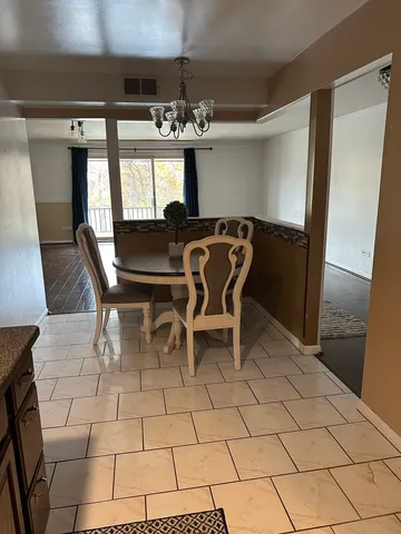 a dining room with furniture and chandelier