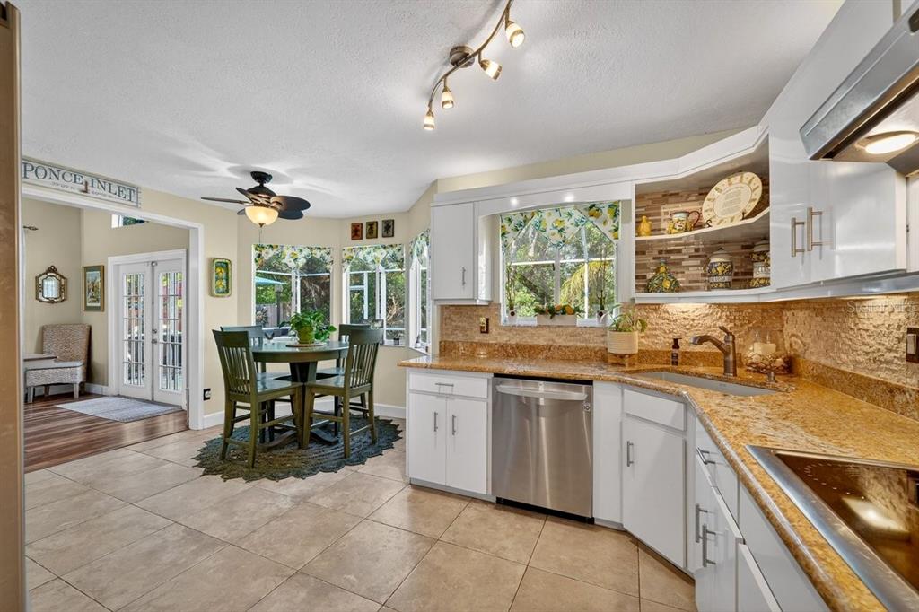 4758 South Peninsula Drive Ponce Inlet, FL 32127 - Photo 13 of 53 a open kitchen with stainless steel appliances granite countertop a sink and cabinets