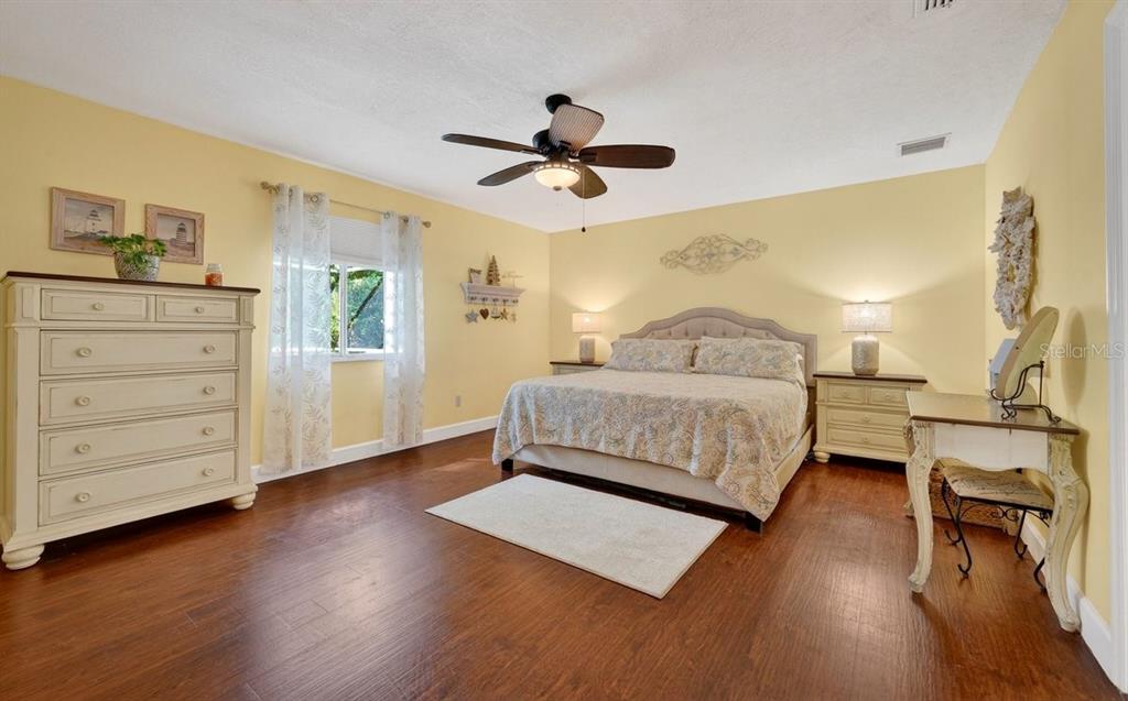4758 South Peninsula Drive Ponce Inlet, FL 32127 - Photo 18 of 53 a bedroom with a bed and wooden floor