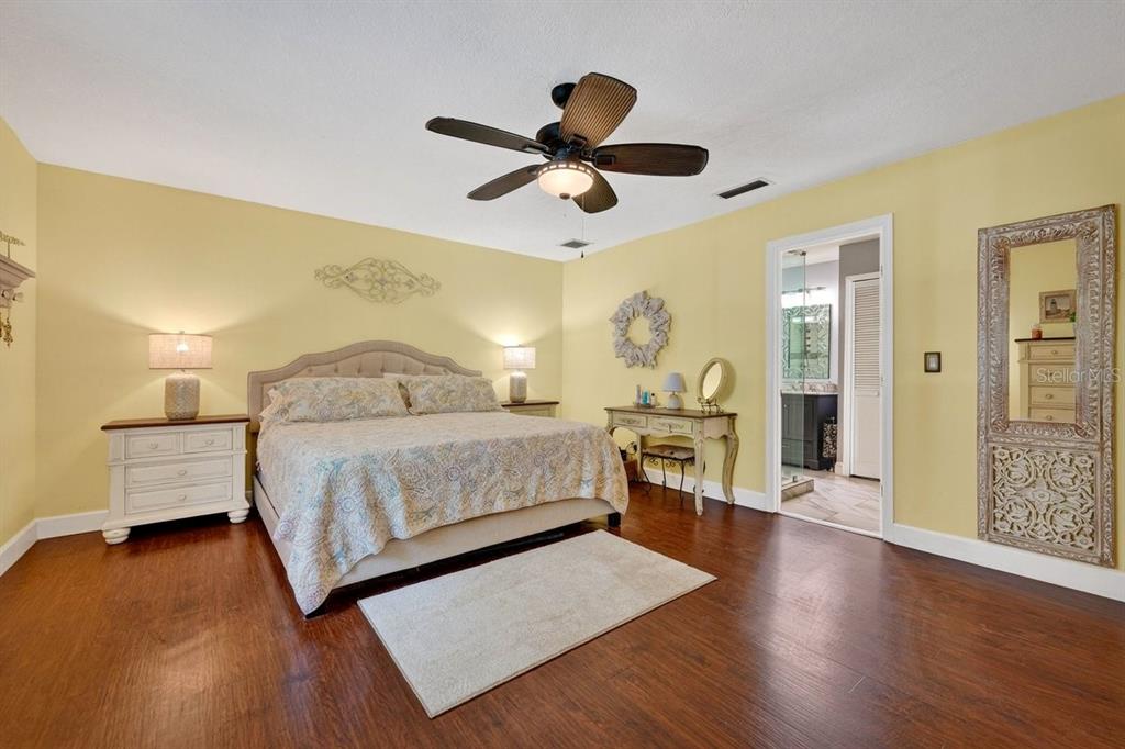 4758 South Peninsula Drive Ponce Inlet, FL 32127 - Photo 19 of 53 a bedroom with a bed chandelier and a window