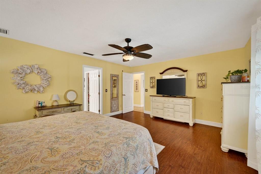 4758 South Peninsula Drive Ponce Inlet, FL 32127 - Photo 20 of 53 a bedroom with a bed and a chandelier