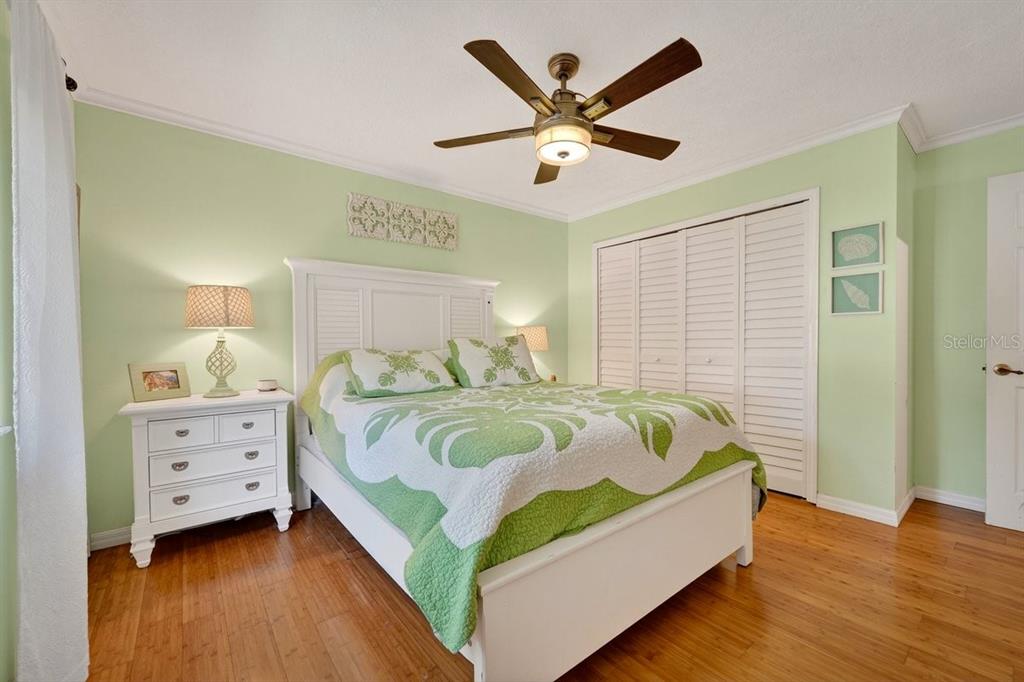 4758 South Peninsula Drive Ponce Inlet, FL 32127 - Photo 31 of 53 a bedroom with a bed and a chandelier