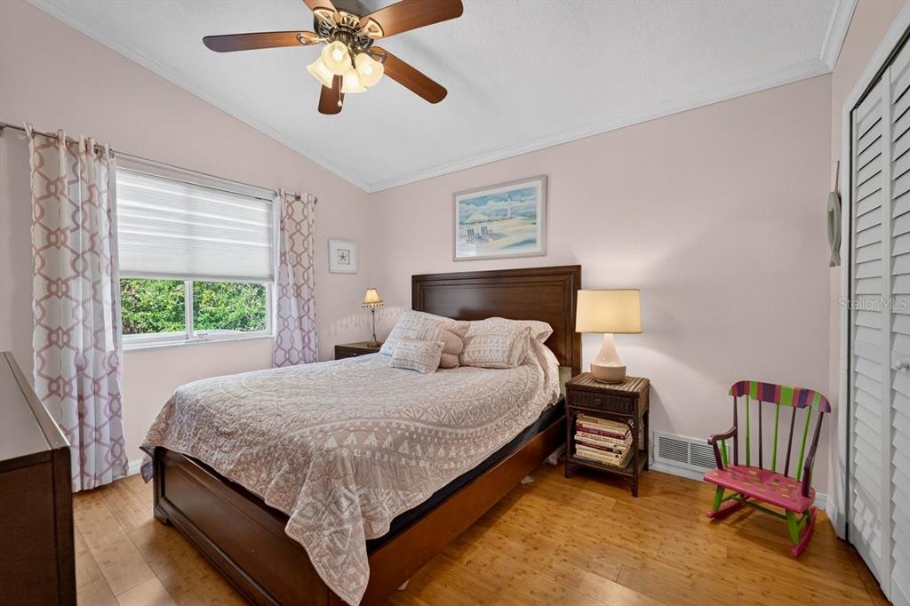 4758 South Peninsula Drive Ponce Inlet, FL 32127 - Photo 32 of 53 a bedroom with a bed and a chandelier