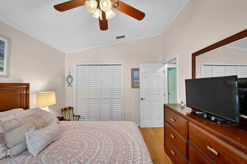 4758 South Peninsula Drive Ponce Inlet, FL 32127 - Photo 33 of 53 a bedroom with a bed and a flat screen tv