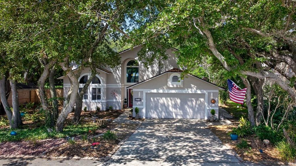 4758 South Peninsula Drive Ponce Inlet, FL 32127 - Photo 36 of 53 a front view of a house with a yard and large trees