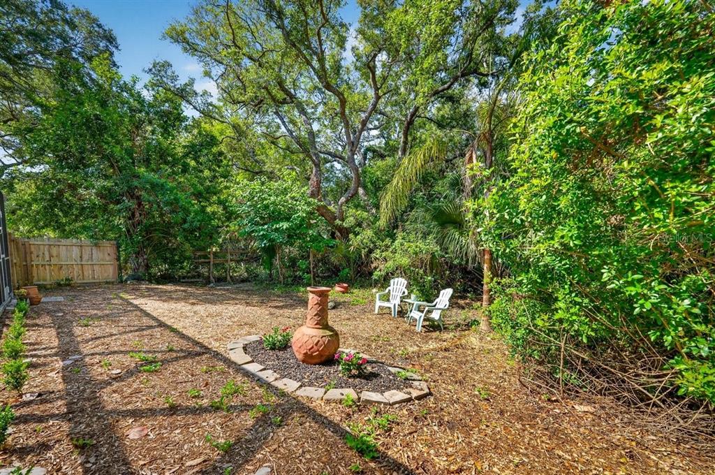 4758 South Peninsula Drive Ponce Inlet, FL 32127 - Photo 46 of 53 a view of a backyard with table and chairs