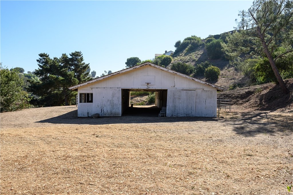 4 Poppy Trail Rolling Hills, CA 90274 - Photo 13 of 22 a house with trees in the background