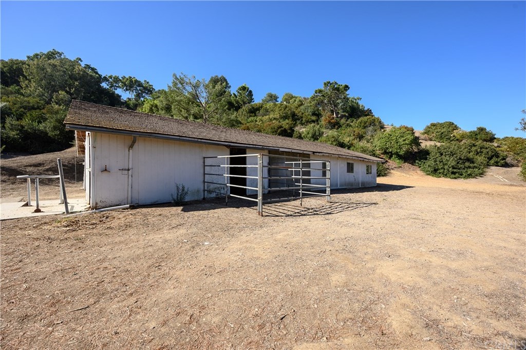 4 Poppy Trail Rolling Hills, CA 90274 - Photo 18 of 22 a backyard of a house with wooden fence and large trees