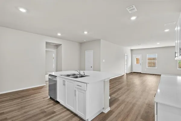 a kitchen that has a lot of cabinets in it