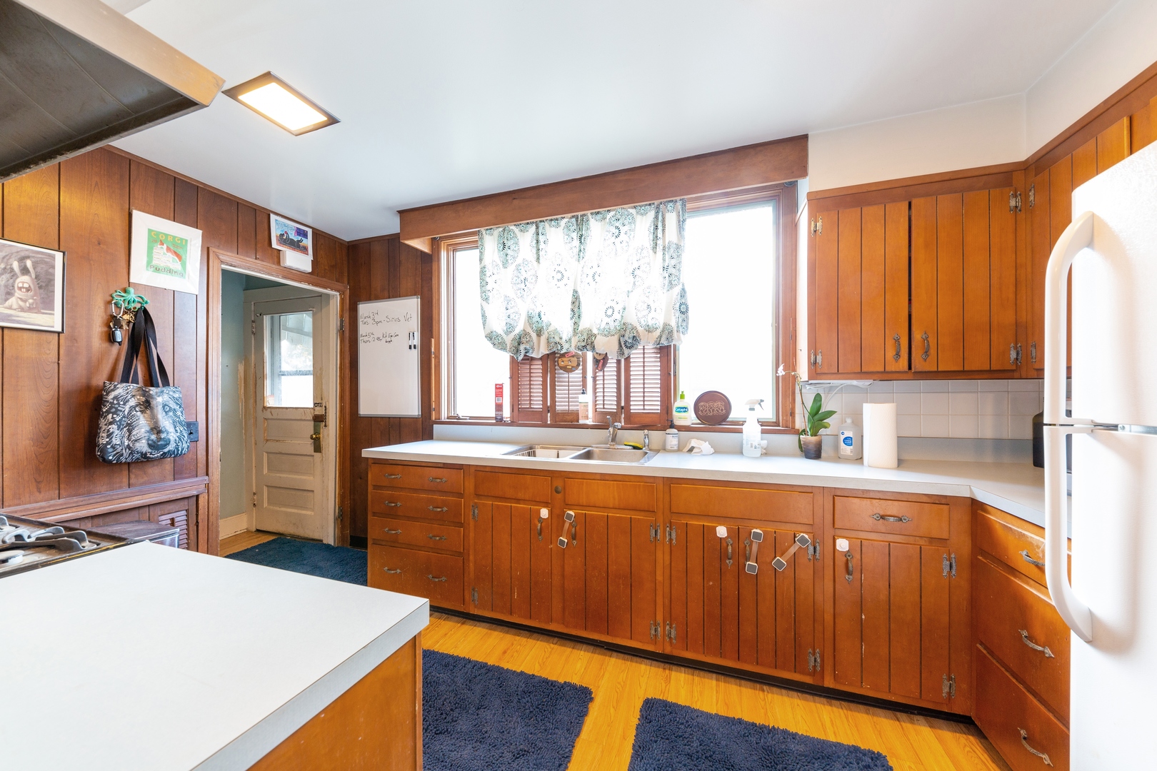 870 Half Day Road Highland Park, IL 60035 - Photo 4 of 10 a large kitchen with stainless steel appliances granite countertop a refrigerator a sink dishwasher and wooden cabinets with wooden floor