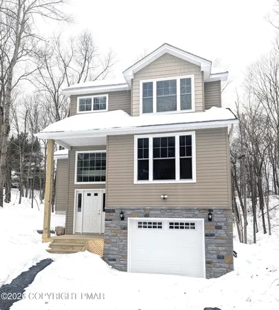 a large kitchen with kitchen island a stove a sink a center island and wooden floor