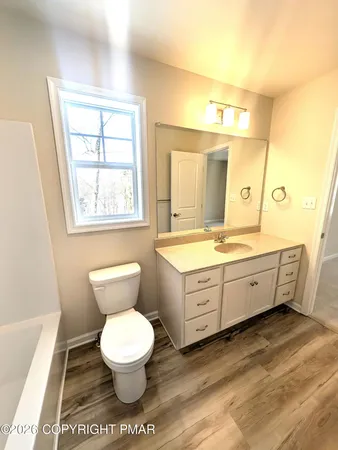 an empty room with a window and a ceiling fan