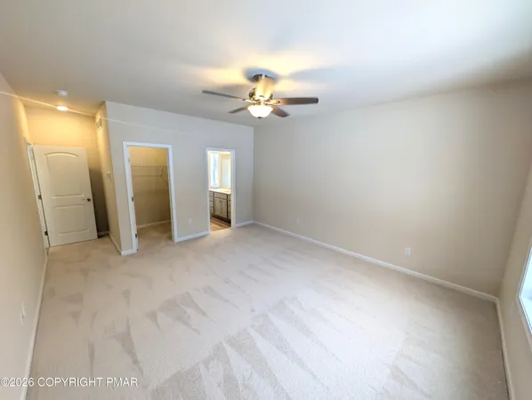 a large kitchen with kitchen island granite countertop a large window a sink and stainless steel appliances