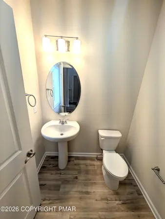 a view of a room with wooden floor and white walls