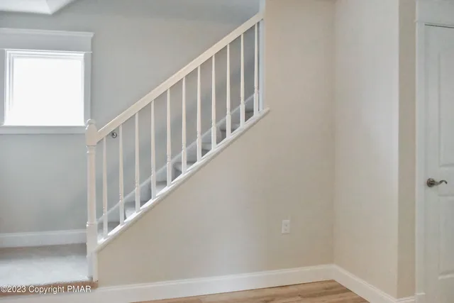 an empty room with windows and closet