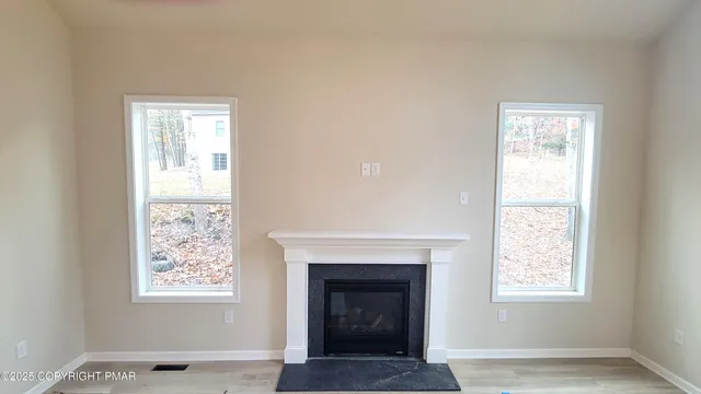 a living room with a fireplace and windows