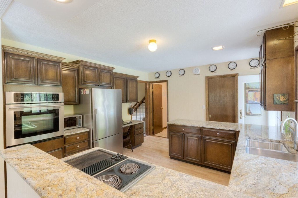 4 Hawthorne Road Wilbraham, MA 01095 - Photo 13 of 29 a kitchen with stainless steel appliances kitchen island granite countertop a refrigerator and a stove