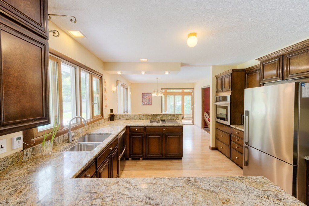 4 Hawthorne Road Wilbraham, MA 01095 - Photo 3 of 29 a large kitchen with kitchen island a large counter top space a sink stainless steel appliances and cabinets