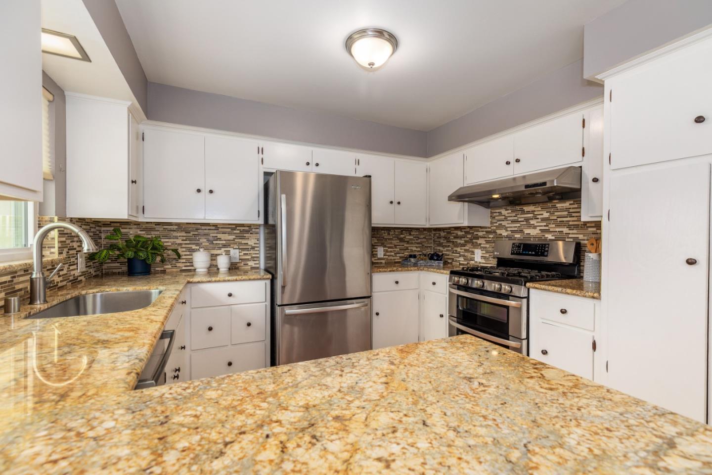 2479 Longview Drive San Leandro, CA 94577 - Photo 15 of 57 a kitchen with granite countertop a refrigerator and a sink