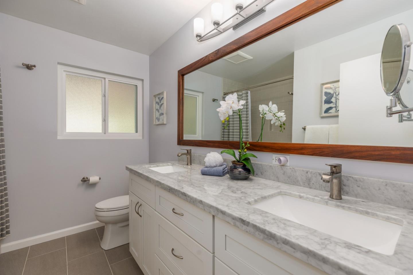 2479 Longview Drive San Leandro, CA 94577 - Photo 26 of 57 a bathroom with a granite countertop sink a toilet and a mirror