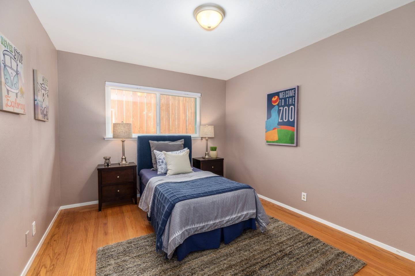 2479 Longview Drive San Leandro, CA 94577 - Photo 27 of 57 a bedroom with a bed and a lamp on dresser