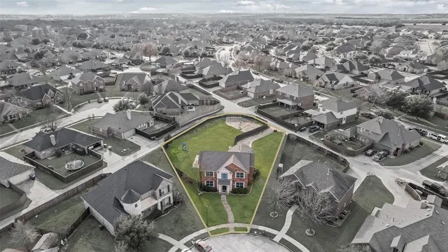 an aerial view of a house with a yard