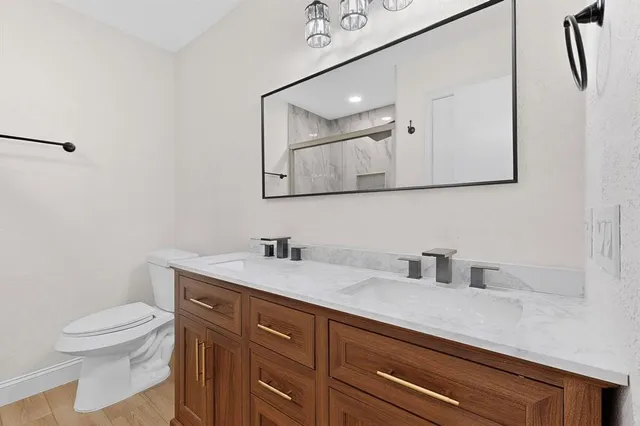 a bathroom with a double vanity sink mirror and