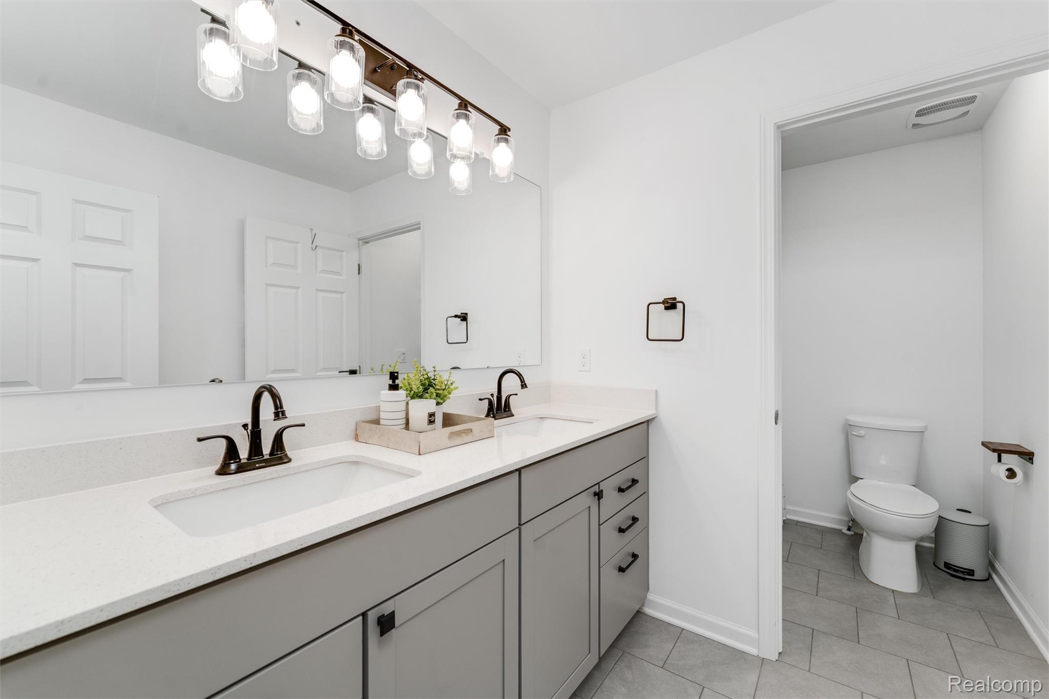 908 South Livernois Road Rochester, MI 48309 - Photo 33 of 49 Bathroom with double vanity and light tile patterned floors