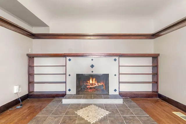 a view of a big room with wooden floor and windows