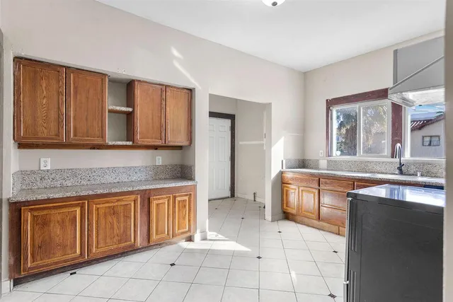 a spacious bathroom with a granite countertop sink and a mirror