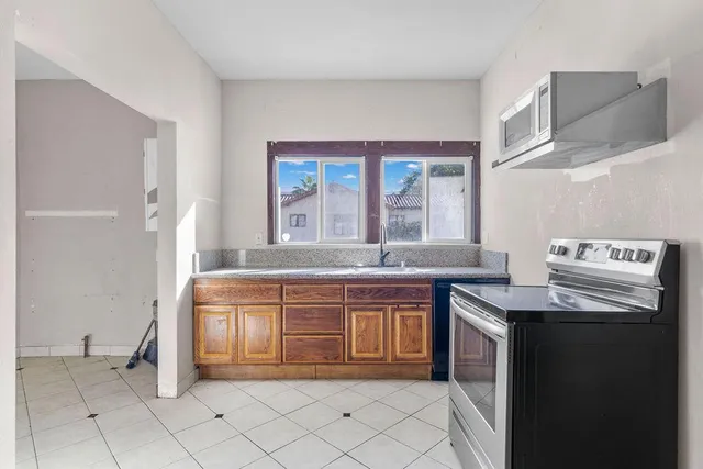a view of an empty room with closet and a window