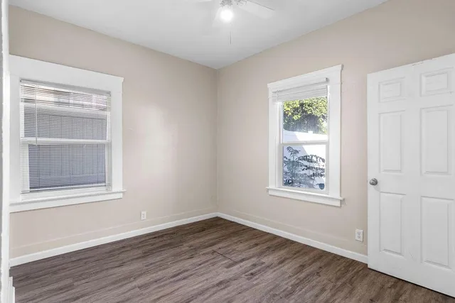 wooden floor in an empty room with a window