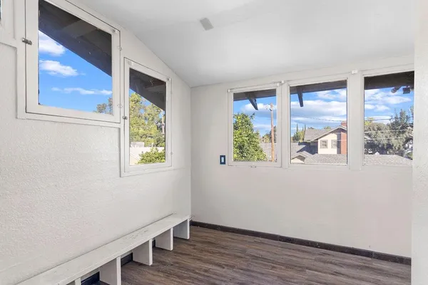 a view of a hallway with wooden floor