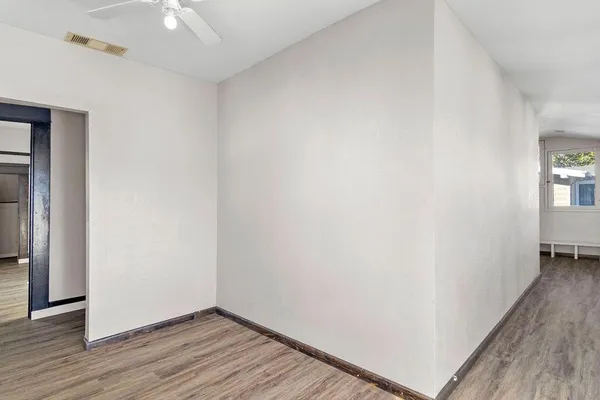 a view of a room with wooden floor